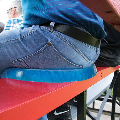 Blue silicone egg cushion under a person on a bench platform