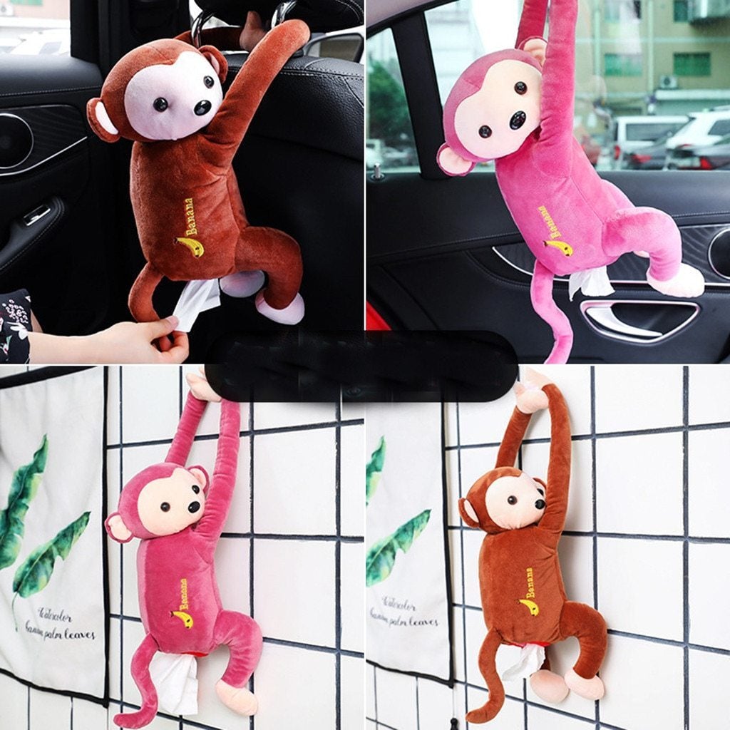Plush monkey tissue holders in brown and pink, hanging on car seat and door