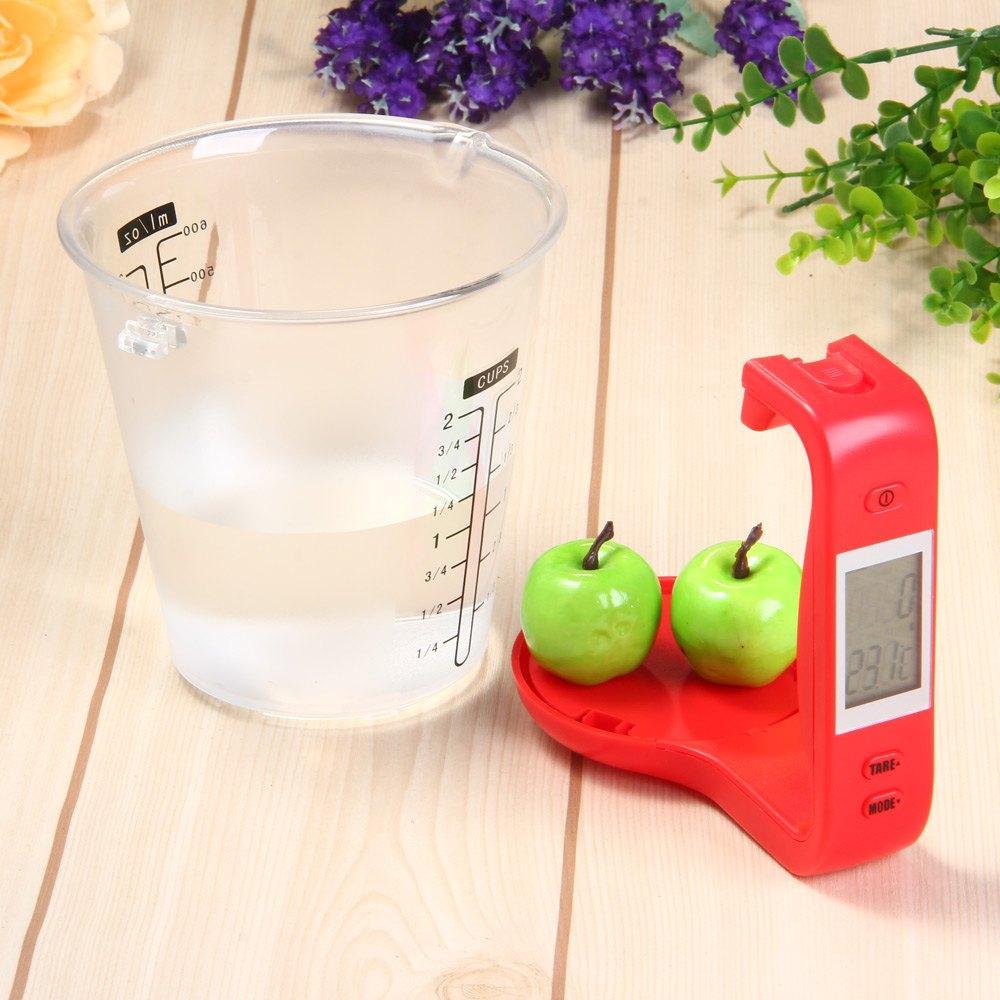 Red digital LCD measuring cup scale with clear cup, tare buttons, and LCD