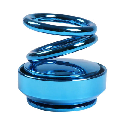 Blue double-ring car air freshener with glossy swirling loops on a round base