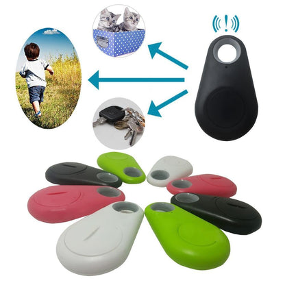 Bluetooth tracker tags with lanyard holes: black, red, white, and green.