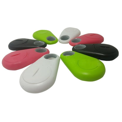 Bluetooth tracker tags with lanyard holes in red, white, black, and green.