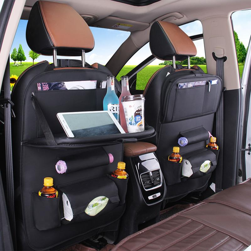 Car seat organizer with tray in black leather with tablet holder, drink bottle cup, and pouches.