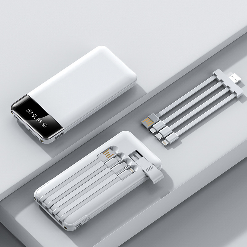 White portable power bank with LED screen, charging ports, and accessories in tray.