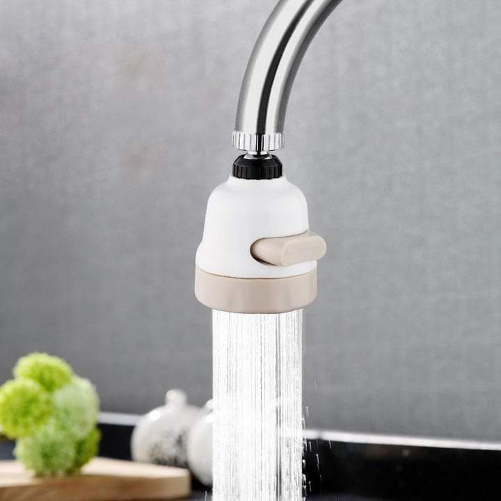 White faucet aerator on sink faucet head, showing aerated water stream