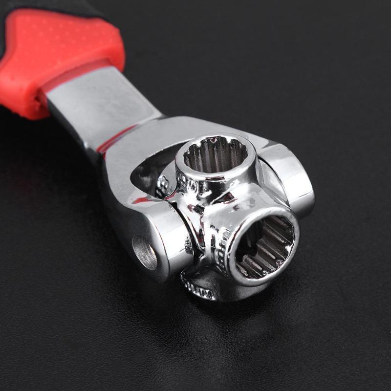 Close-up of chrome socket head on universal wrench with red handle