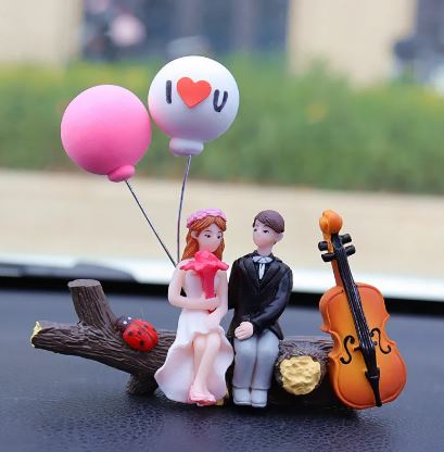 Wedding couple car figurines in formal wear with heart balloon and cello