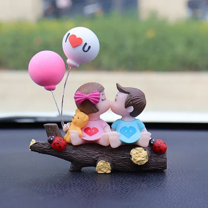 Couple car decoration figurine set on dark wood base with balloons and heart symbols