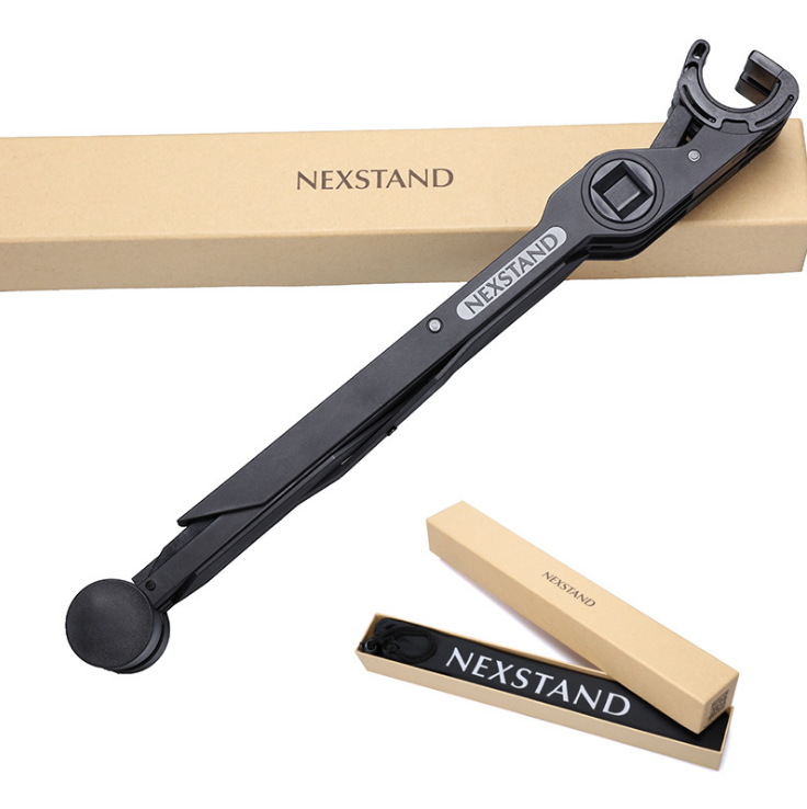 Black foldable laptop stand with NEXSTAND logo beside retail box