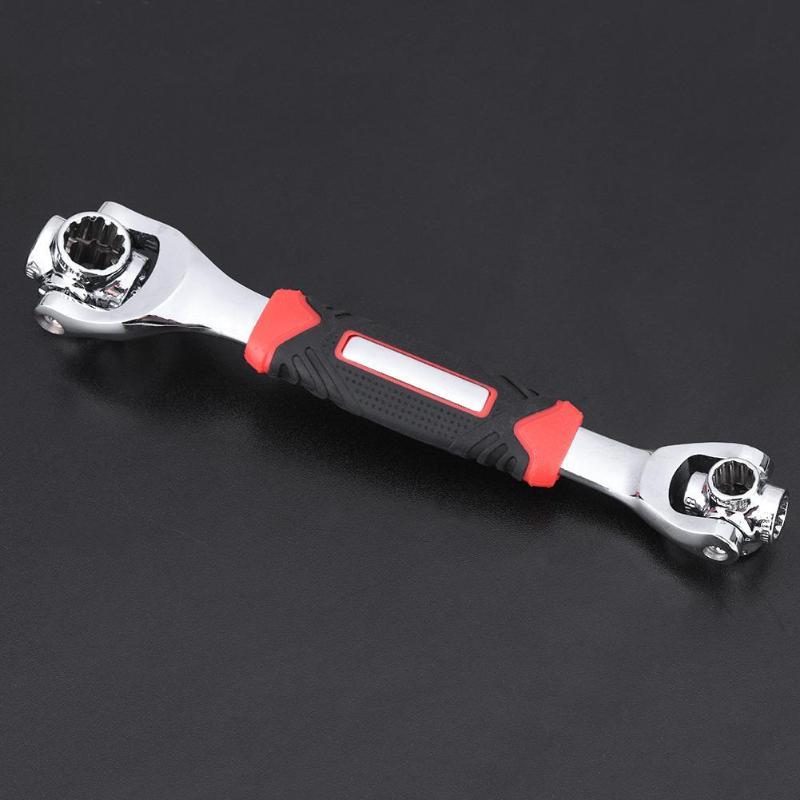 Universal socket wrench tool on dark background with chrome head and red-black grip