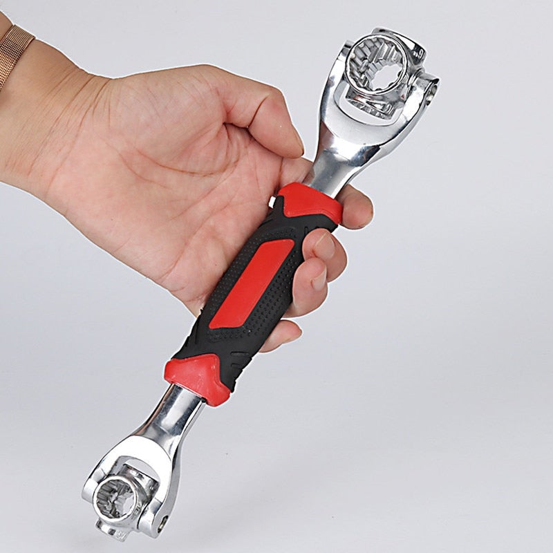 Hand holding universal socket wrench tool with chrome ratchet head and red-black handle