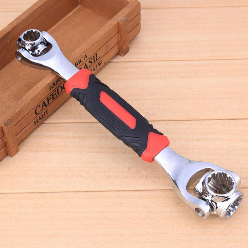 Universal socket wrench tool resting on wood surface with red-black handle