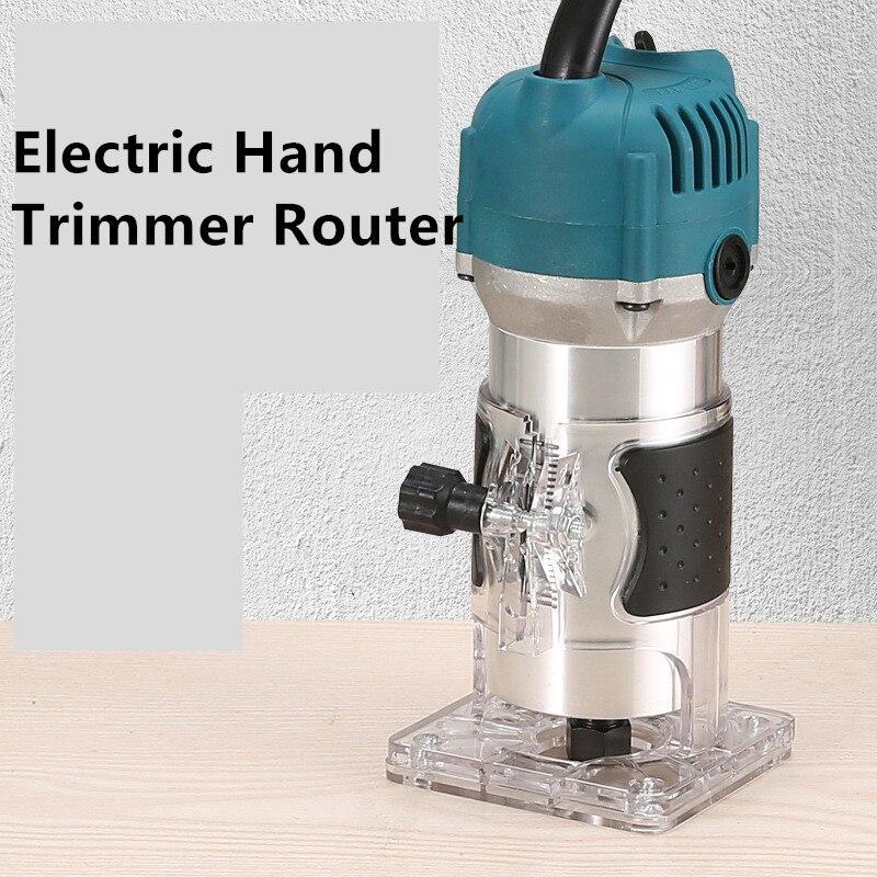 Electric hand trimmer router with teal motor, transparent base on wood