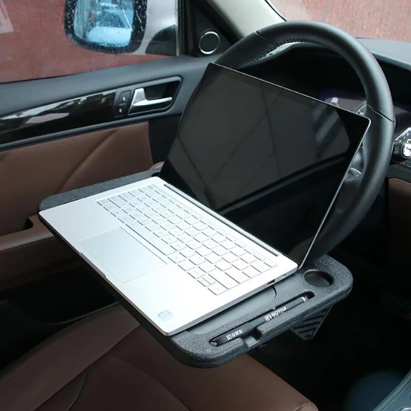Car steering wheel tray with tablet resting on the front console