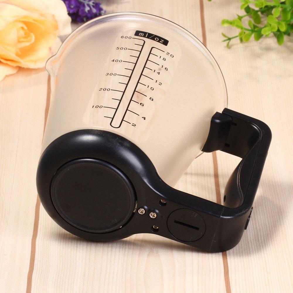 Clear measuring cup scale with black base and LCD display, cup markings visible