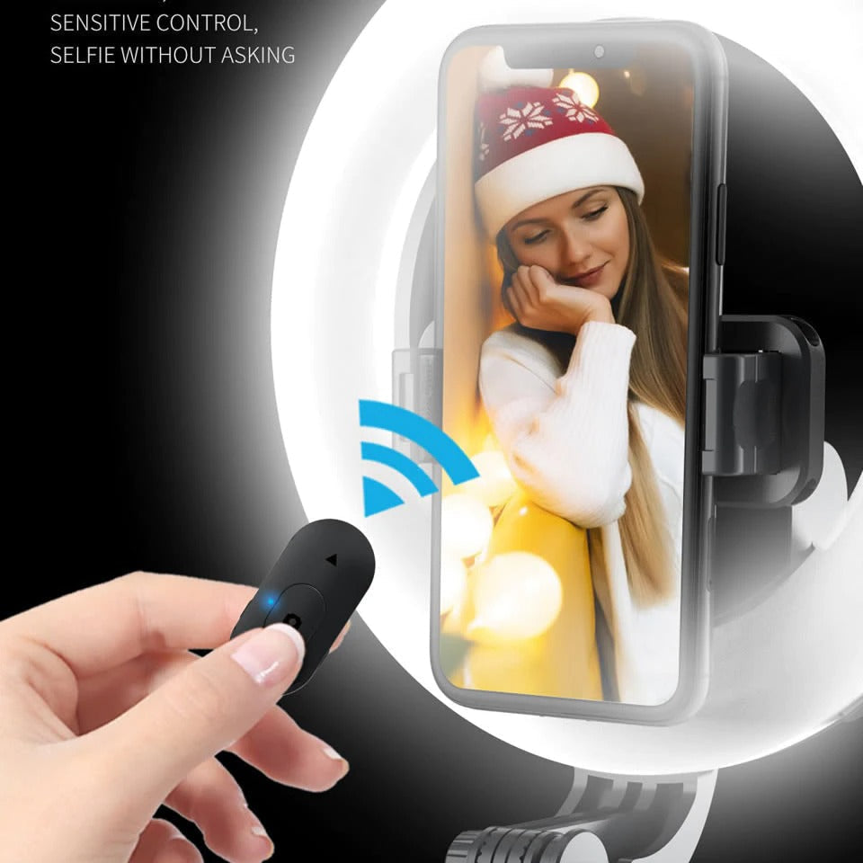 Ring light selfie stick with smartphone in mount and handheld remote controller