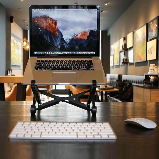 Black portable adjustable laptop stand with open X-frame base for desk use