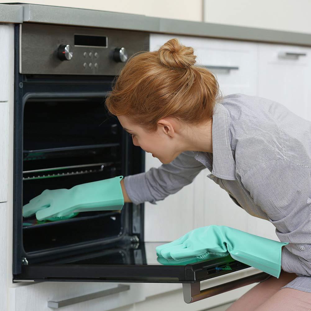 Green silicone dishwashing glove reaching into an oven to wipe interior