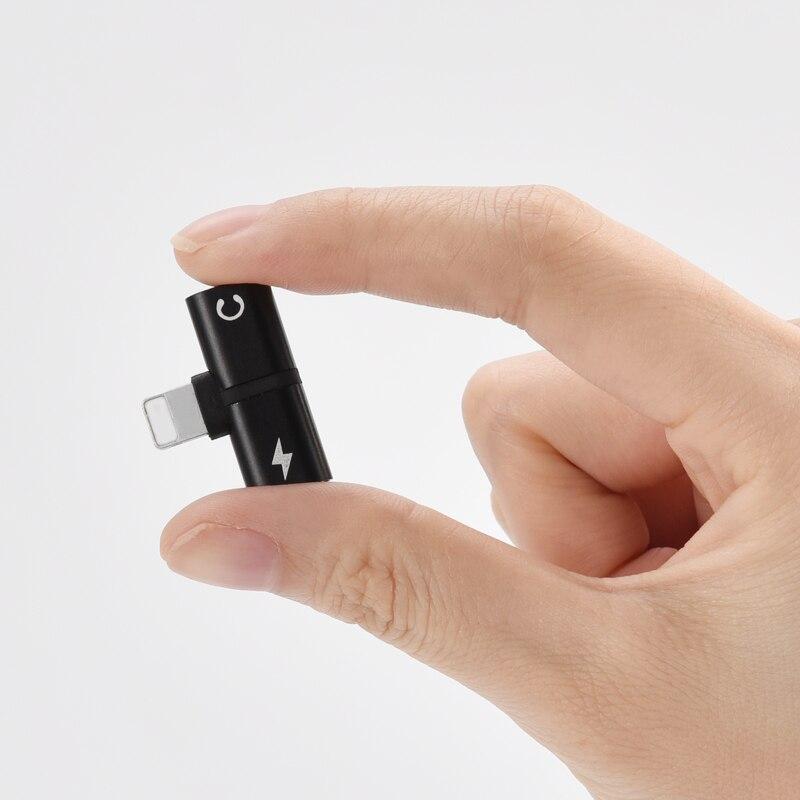 2-in-1 audio and charging adapter in hand, black USB-C plug with audio output